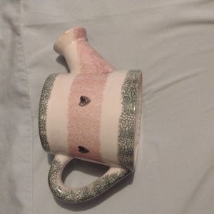 A clay watering can